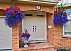 OLYMPUS DIGITAL CAMERA  Double door front entrance archway with hanging baskets.