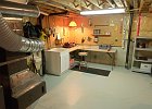 Workshop Storage Room  Unfinished furnace room with workshop, laundry tub and storage shelves.