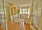 Living Room  Living room with maple hardwood floor and bay window.
