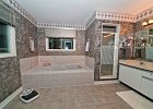 OLYMPUS DIGITAL CAMERA  Huge 5-pc ensuite master bath with two sinks and windows.